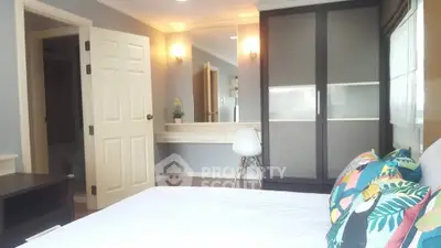 Spacious bedroom with modern wardrobe and cozy decor