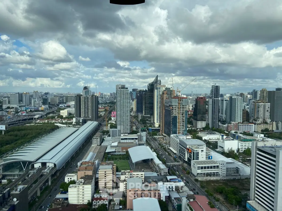 Stunning cityscape view showcasing modern skyscrapers and urban landscape under a dramatic cloudy sky.
