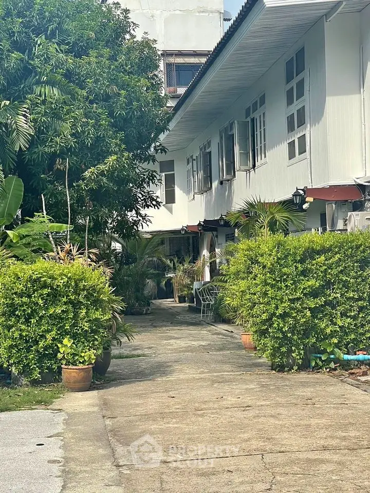 Charming residential property with lush greenery and inviting pathway