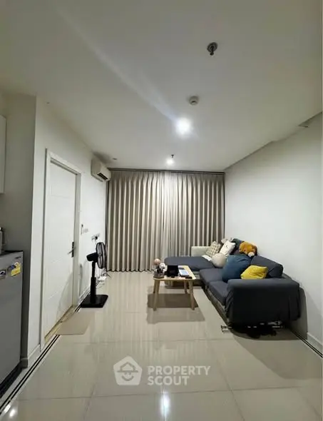 Modern living room with sleek furniture and elegant curtains, perfect for cozy gatherings.