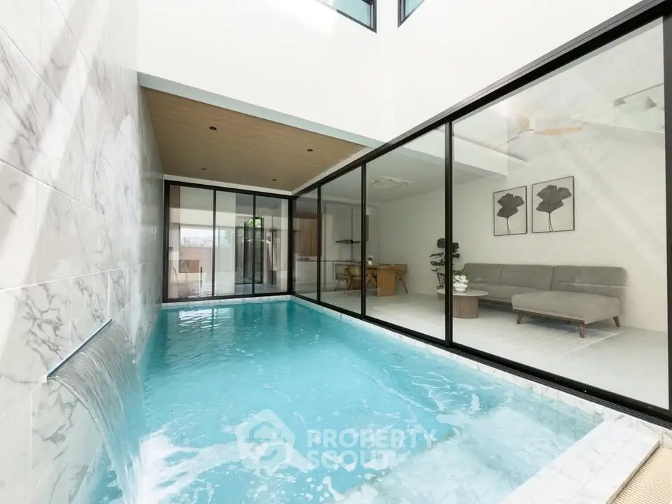 Luxurious indoor pool with modern design and elegant living area view