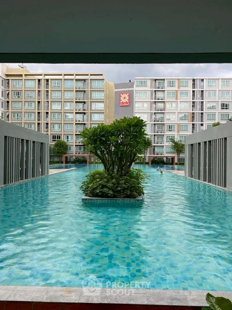 Luxurious apartment complex with stunning pool and modern architecture.