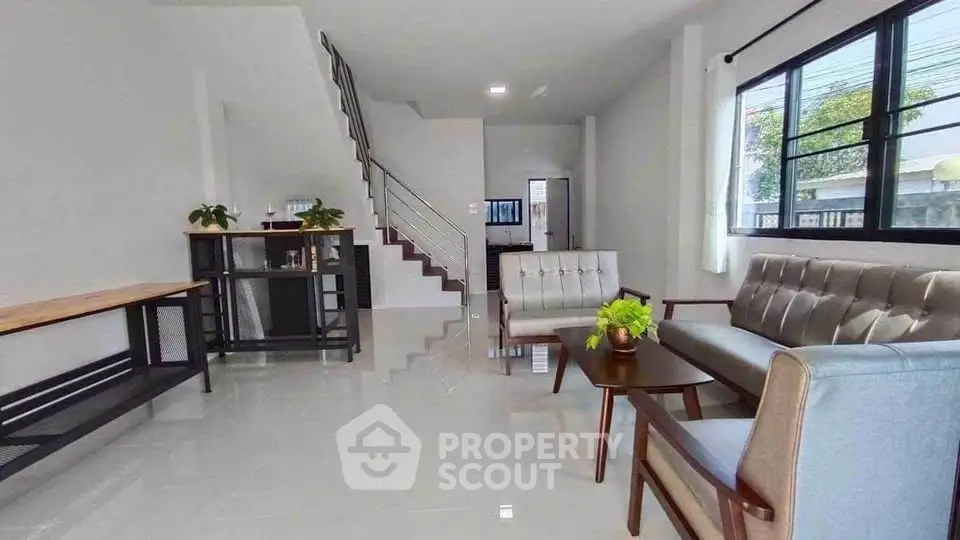 Spacious modern living room with sleek furniture and natural light