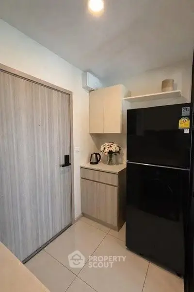 Modern kitchen with sleek black fridge and stylish cabinetry