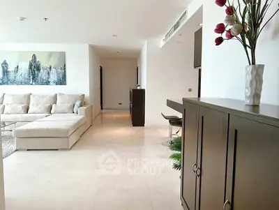 Spacious modern living room with elegant decor and large sectional sofa in a luxury apartment.