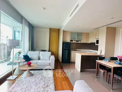 Modern open-plan living room with kitchen and balcony view