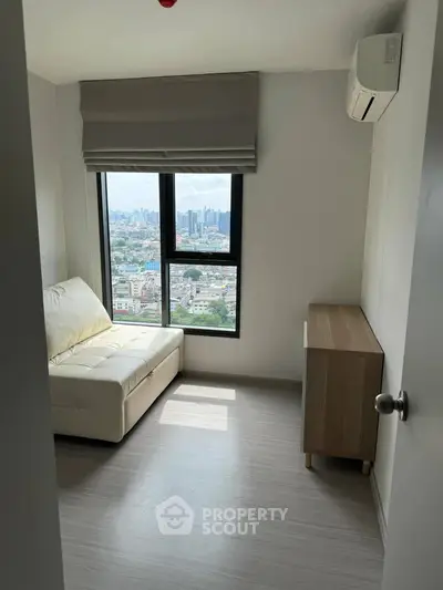 Cozy room with city view, featuring a white sofa and air conditioning, perfect for relaxation.