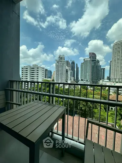 Stunning city view from a modern balcony with sleek furniture, perfect for urban living.