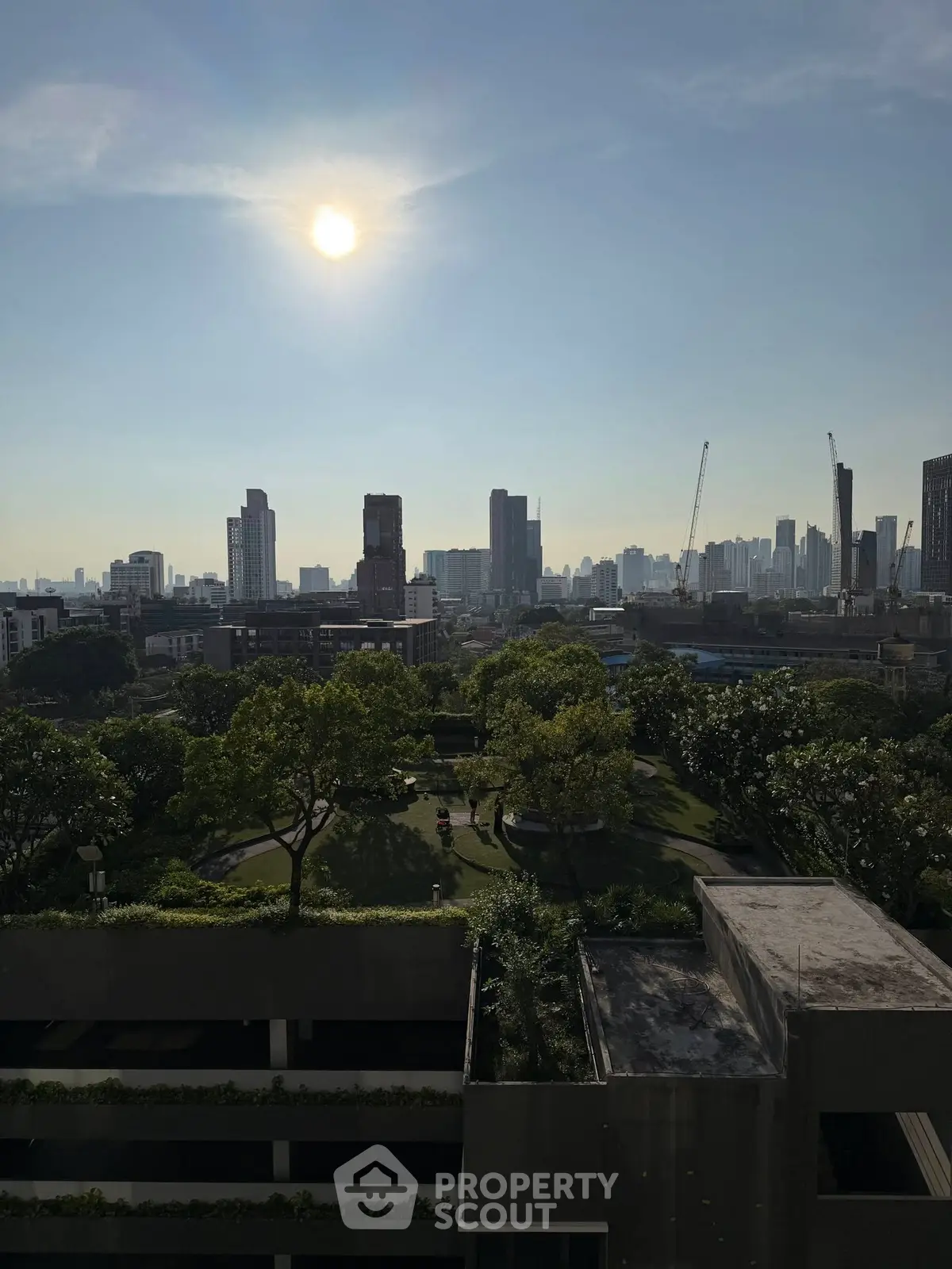 Stunning cityscape view from high-rise building with lush green park below