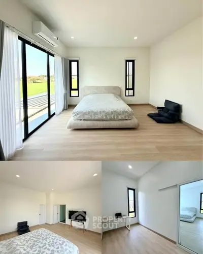 Spacious bedroom with large windows and minimalist decor, offering serene views and ample natural light.