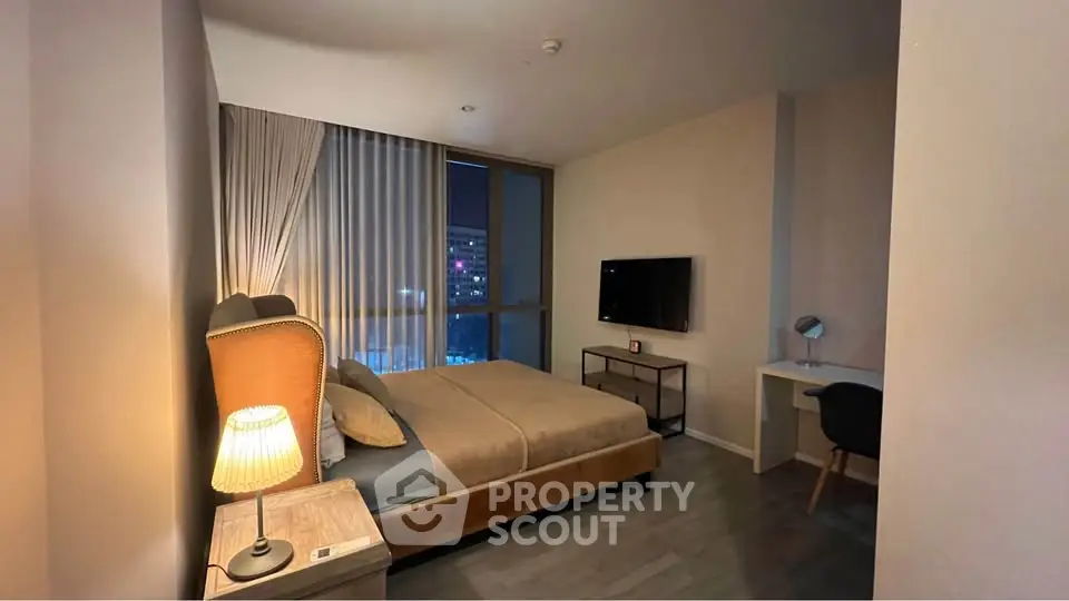 Modern bedroom with city view, featuring cozy bed, stylish furniture, and ambient lighting for a serene atmosphere.