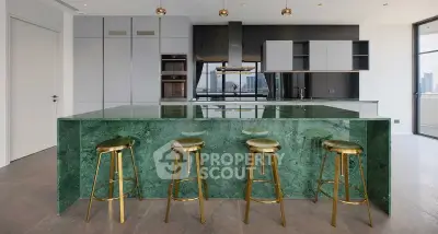 Luxurious modern kitchen with green marble island and city view, featuring sleek cabinetry and gold bar stools.
