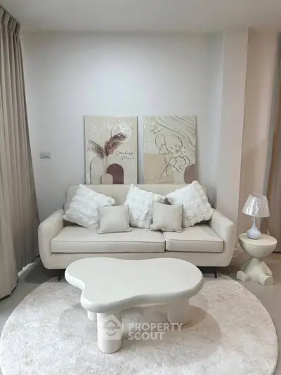 Elegant living room with modern white sofa and artistic decor