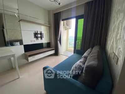 Modern living room with stylish sofa and balcony view, perfect for relaxation and comfort.