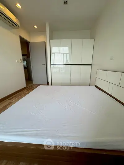 Spacious bedroom with modern design and ample natural light