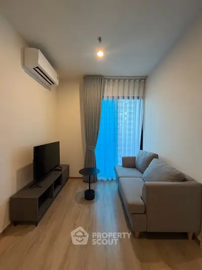 Modern living room with sleek furniture and natural light, perfect for relaxation and entertainment.