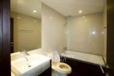 Modern bathroom with sleek fixtures and a bathtub in a contemporary apartment.