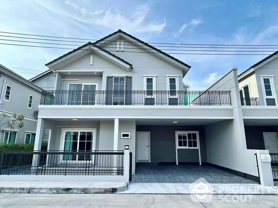 Elegant two-story house with spacious balcony and modern exterior design