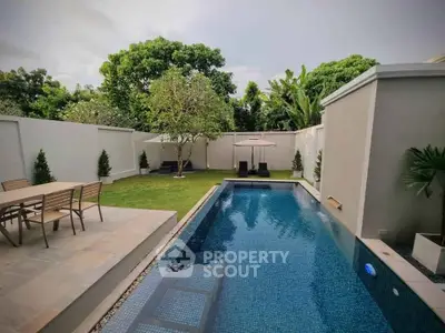 Luxurious backyard with private pool and lush garden, perfect for relaxation and entertainment.