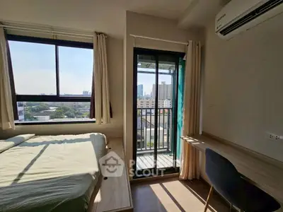 Cozy bedroom with balcony view and natural light in modern apartment.