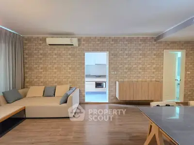 Spacious living room with modern decor and open kitchen layout