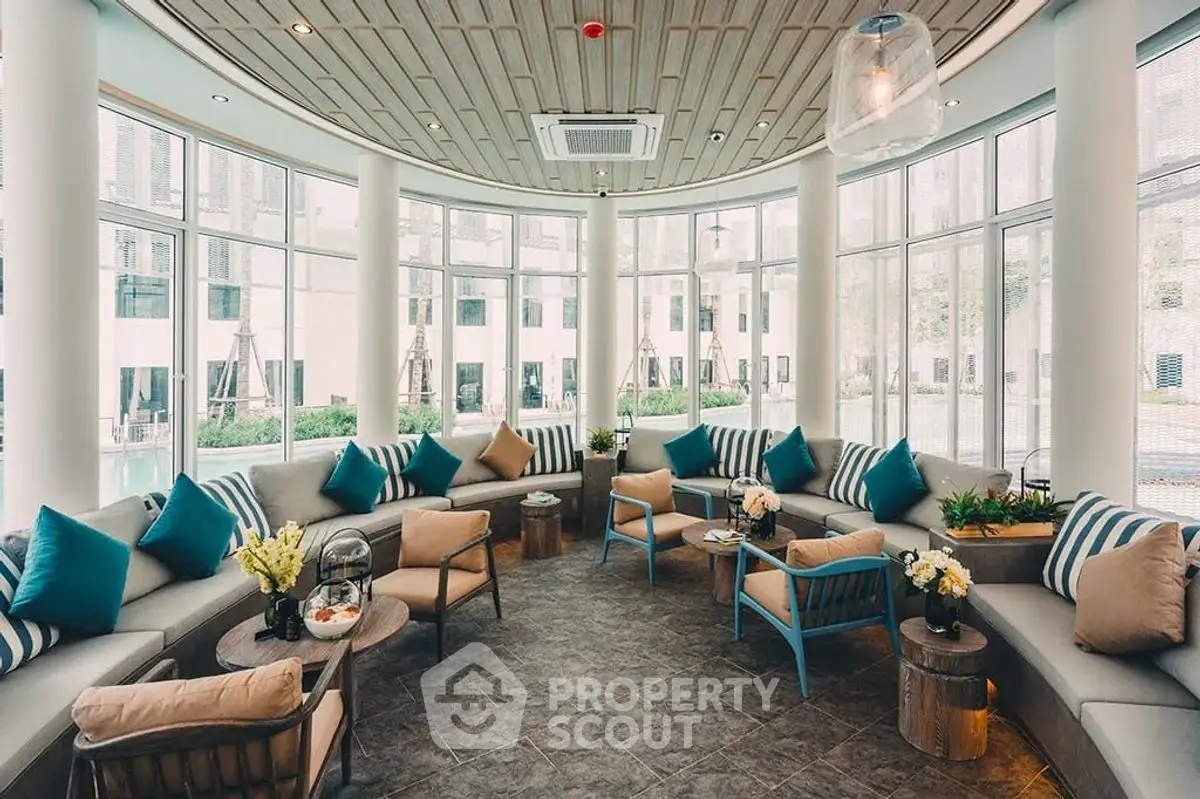 Luxurious curved living room with panoramic windows and stylish decor