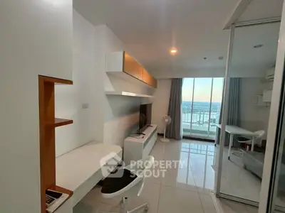 Modern living room with sleek design and stunning city view from balcony.