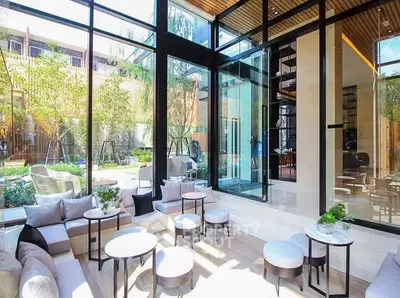 Luxurious modern living room with floor-to-ceiling windows and garden view