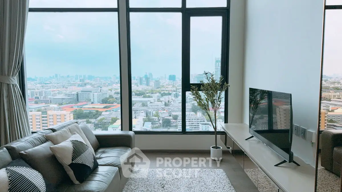 Stunning living room with panoramic city view, modern decor, and cozy seating area.