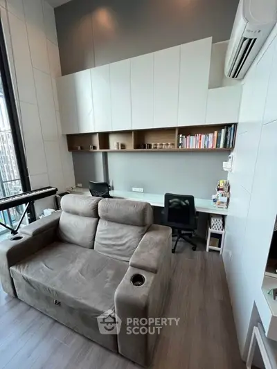 Modern study room with cozy sofa and built-in desk in high-rise apartment