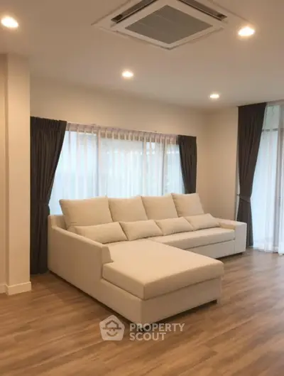 Spacious living room with elegant sofa and natural light