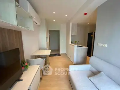 Modern living room with open kitchen layout and stylish furnishings