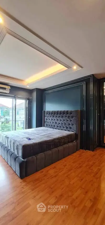 Luxurious bedroom with plush bed and large windows offering a serene view, perfect for relaxation.