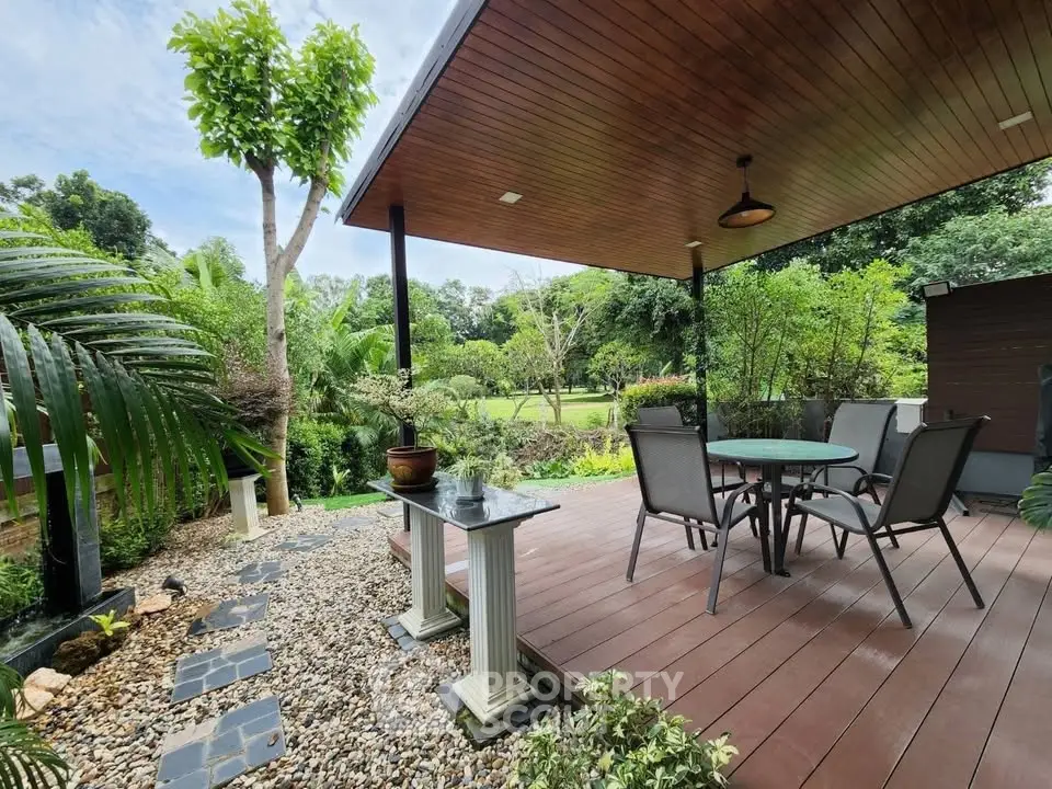 Charming outdoor patio with lush garden view and elegant seating area, perfect for relaxation and entertaining.