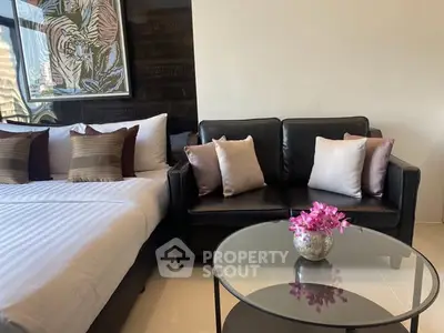 Modern bedroom with stylish decor and cozy seating area