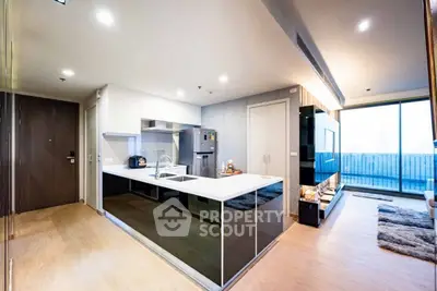 Modern open-layout kitchen and living room with sleek design and large balcony view.