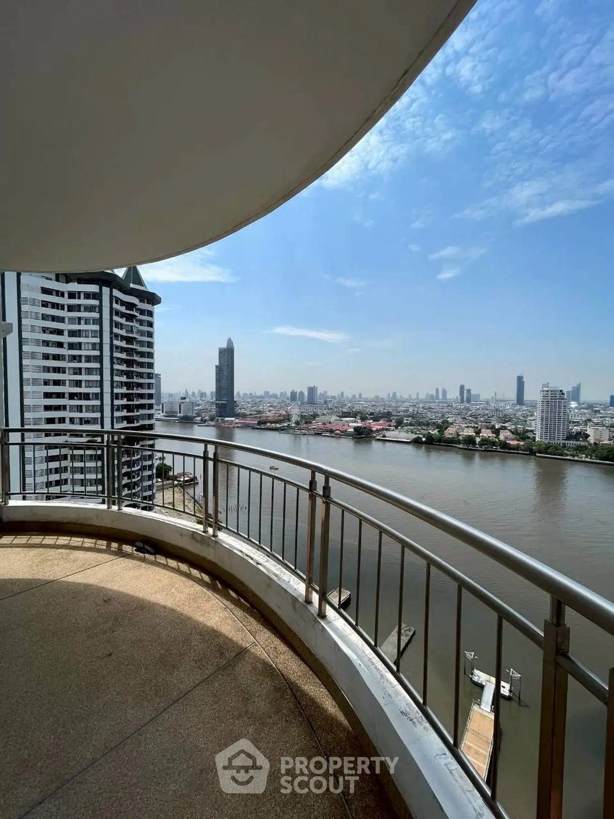 Stunning river view from a spacious balcony in a high-rise apartment.