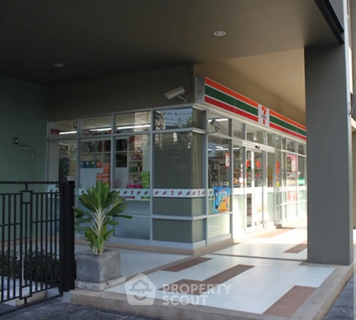 Modern commercial retail space with glass facade and ample walkway.