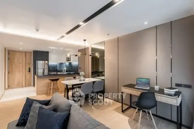 Modern open-plan living room with stylish kitchen and workspace, featuring elegant lighting and contemporary decor.