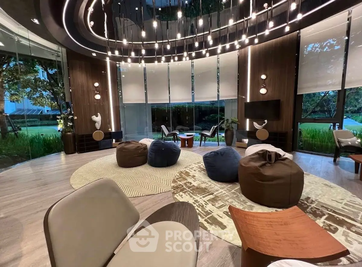 Luxurious modern living room with stylish furniture and large windows offering serene garden views.