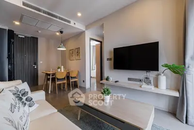 Modern living room with stylish decor and open dining area in a contemporary apartment.