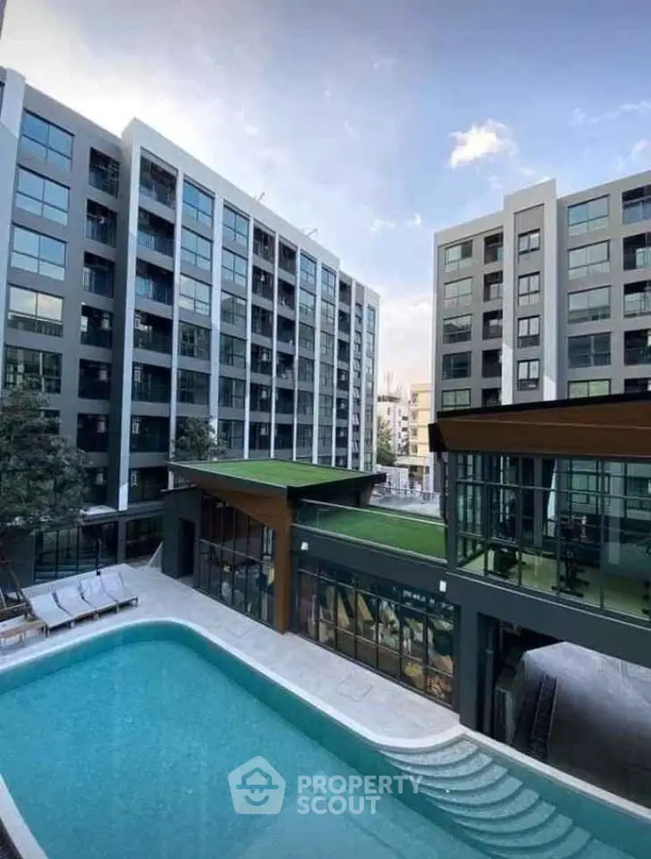 Modern apartment complex with pool and rooftop garden, offering luxury urban living.