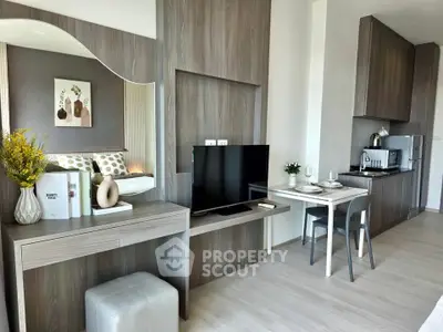 Modern studio apartment with stylish decor and compact kitchen
