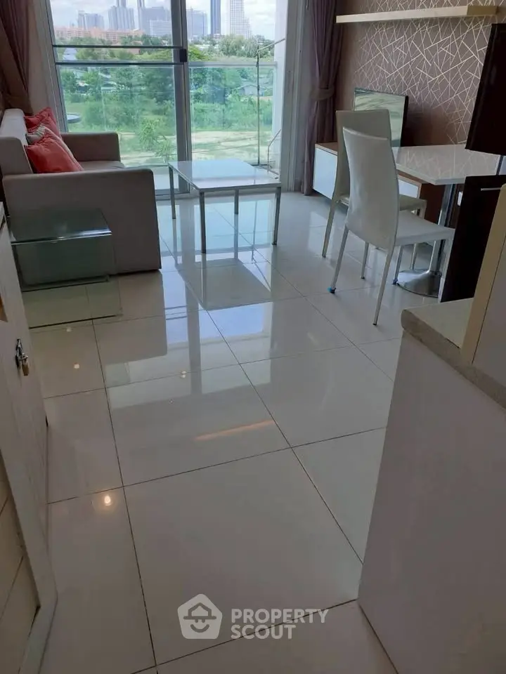 Modern living room with sleek furniture and large windows offering a stunning view.