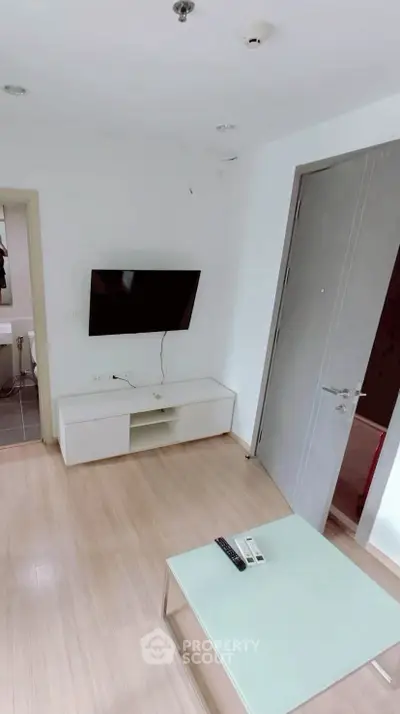 Modern living room with wall-mounted TV and sleek furniture