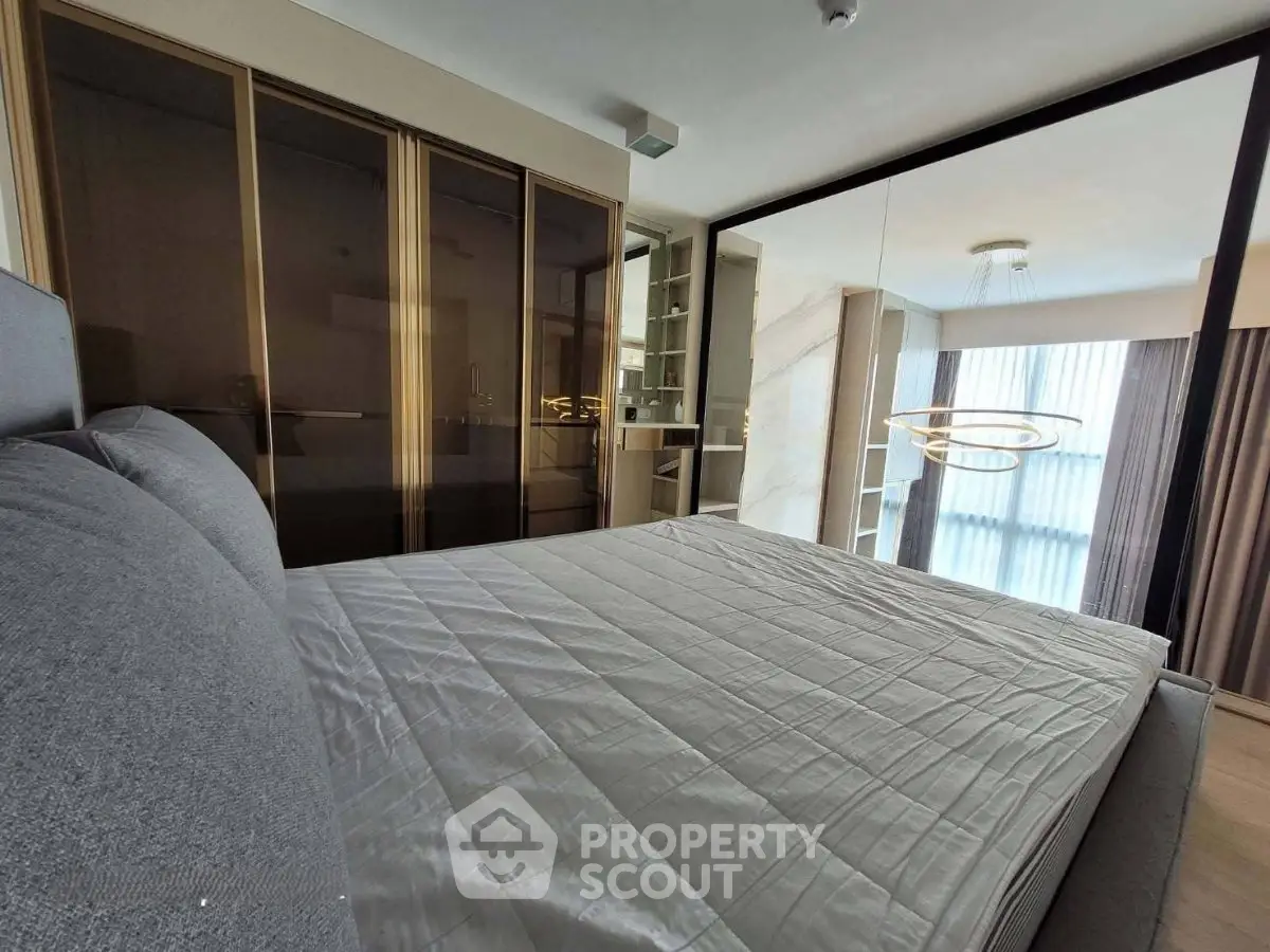 Modern bedroom with sleek design and mirrored wardrobe doors