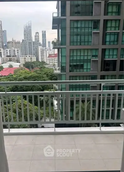 Spacious balcony with cityscape view in modern high-rise building