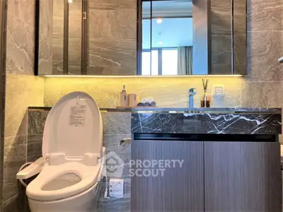 Luxurious modern bathroom with sleek marble finishes and elegant lighting.