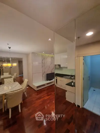 Luxurious modern living room with elegant dining area and sleek kitchen design.