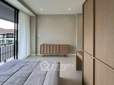 Spacious modern bedroom with large windows and minimalist furniture